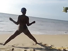 Ebony woman carrying out some exercise leafless between assignments